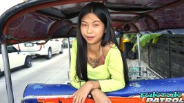 Pretty young Thai chick sits in a tuktuk