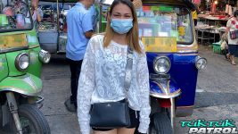 Happy Thai MILF poses for picture next to TukTuk