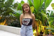 Pretty Filipina poses in front of Philippine plants