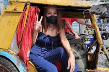 Pretty Pinay throws up a peace sign in trike