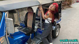 Joyful Asian teen poses next to a tuktuk