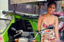 Exotic Filipina poses next to trike in the Philippines