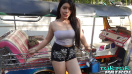 Busty Thai model poses next to tuktuk