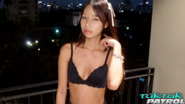 Skinny Thai babe poses in black bara on balcony