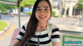 Joyful Thai sits in a tuktuk
