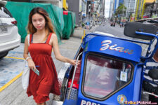 Filipina teen poses near Philippine trike