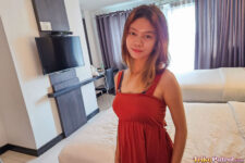 Filipina teen in red dress poses near bed