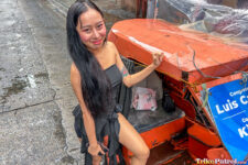 Filipina beauty poses next to Philippine trike