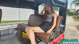 Pretty Thai sits in tuktuk