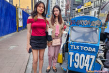 Two Filipina babes pose next to trike