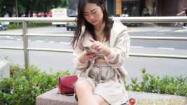 Pretty Taiwan model sits on bench